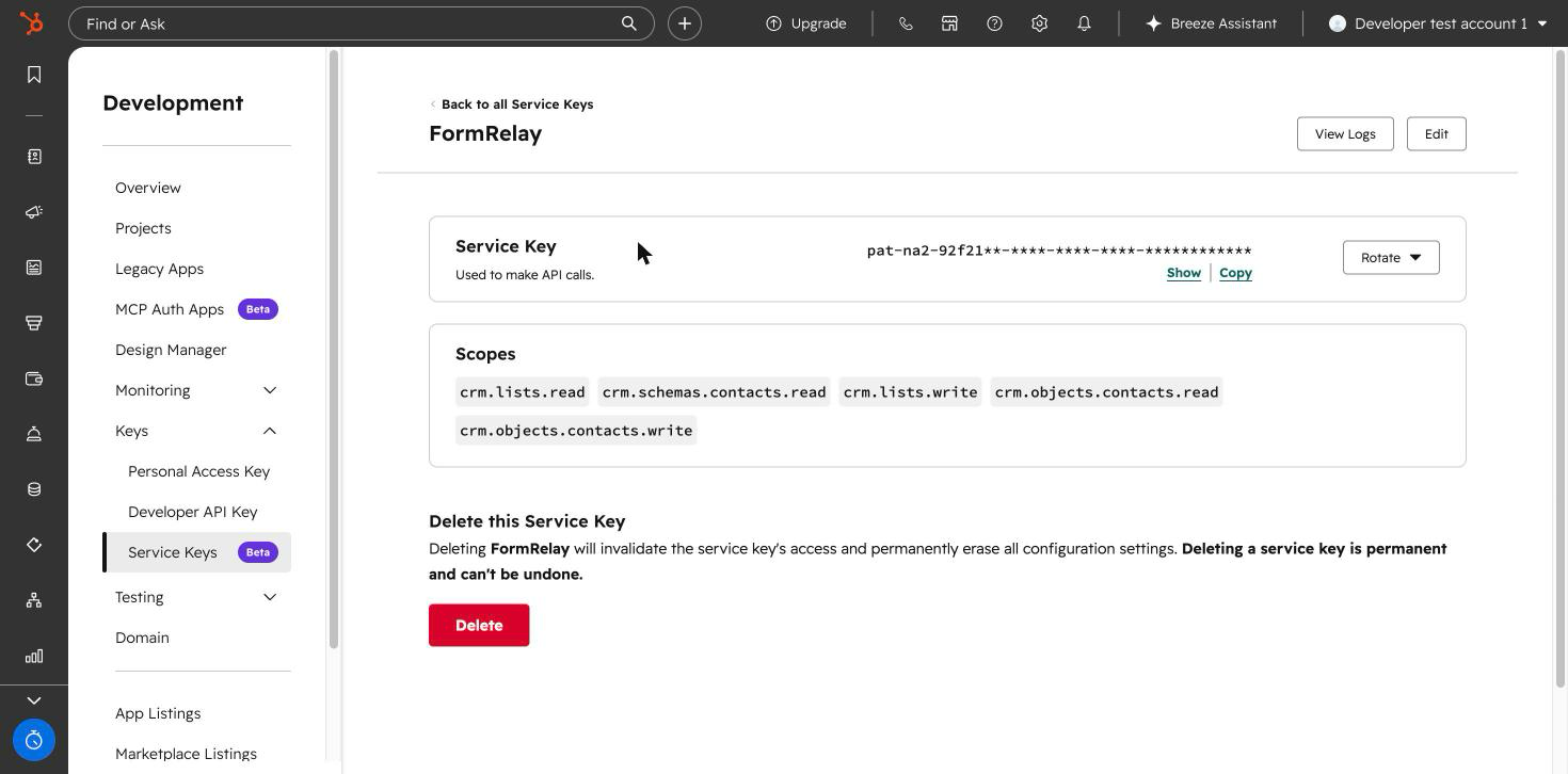 The Service Key screen in HubSpot, with the key masked and its scopes listed